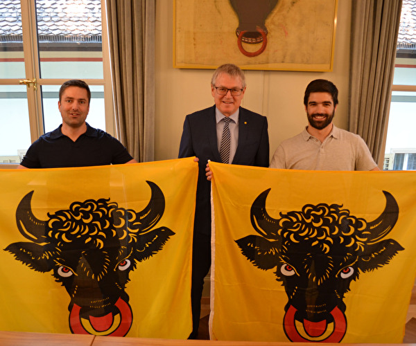 Übergabe der zwei neuen Urnerfahnen durch Landammann Urban Camenzind an Thomas Gisler (links) und Simon Jauch. 