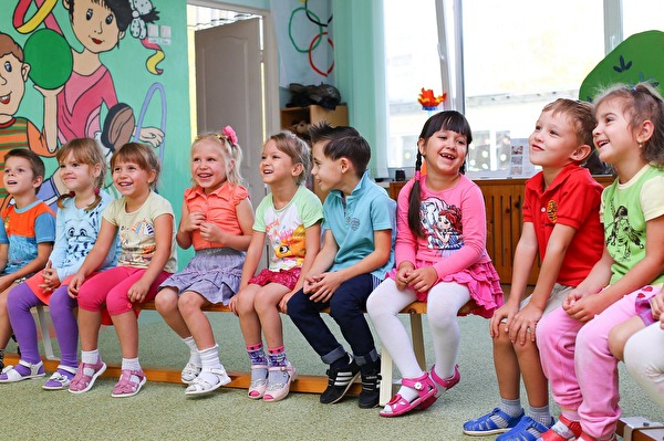 Symbolbild; Kinder sitzen auf Bänkli
