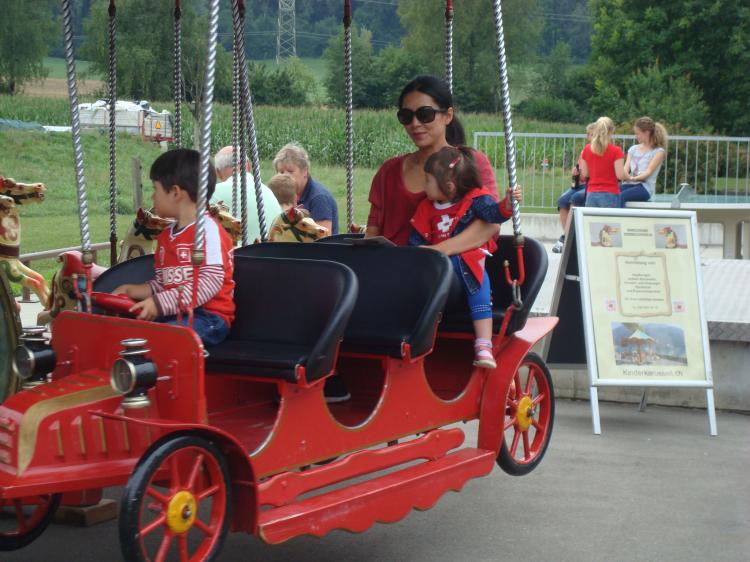 Tien Köppel mit ihren beiden Kindern auf dem Karussell
