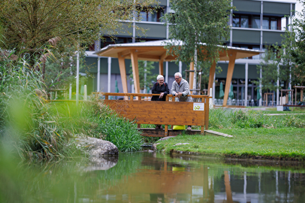Seniorin und Senior unterhalten sich im Stadtpark