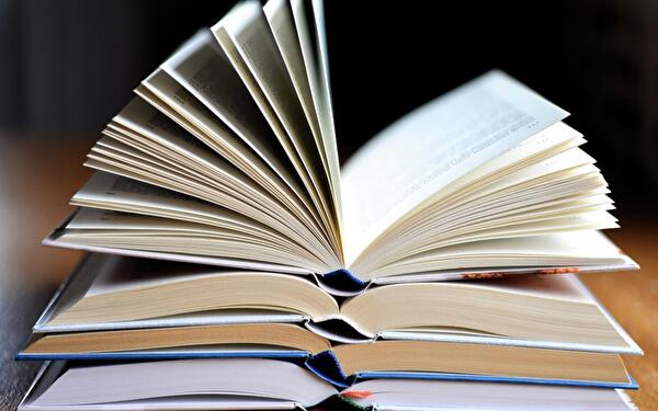 Geöffnete Bücher übereinander liegend. 