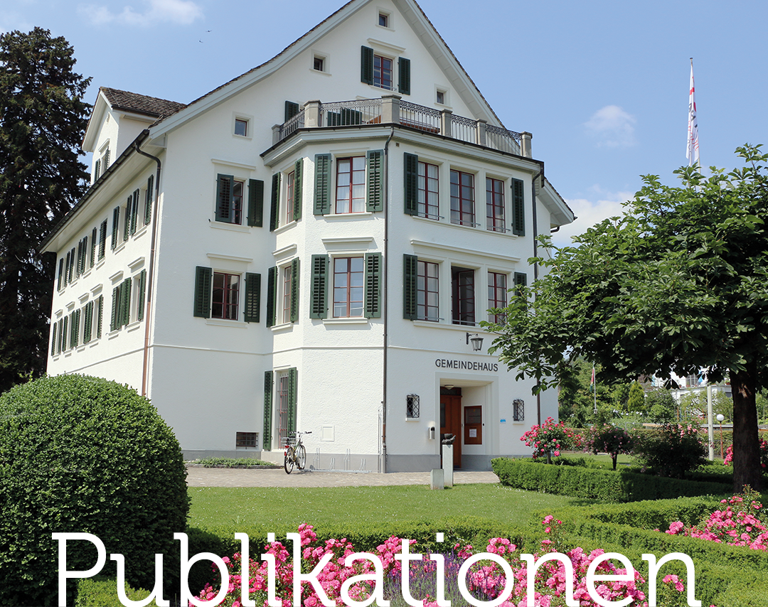 Gemeindehaus im Frühling mit Blumen, Sträucher und Baum im Vordergrund