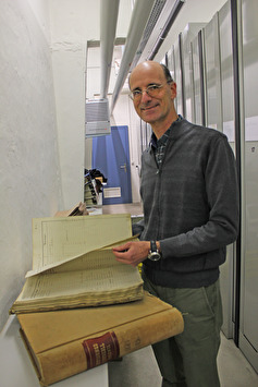 Thomas Friedlin blättert in historischen Brandlagerbüchern