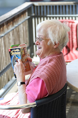 ältere Dame liest ein Taschenbuch