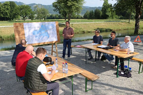 Projektleiter Roland Hollenstein (stehend) stellte zusammen mit Matthias Kreis, Leiter der Melioration der Rheinebene, Sascha Weder, Geschäftsführer des RBK und Roland Wälter, Präsident des Zweckverband Rheintaler Binnenkanal, an der Medienkonferenz das Auf-lageprojekt vor. Foto: pd