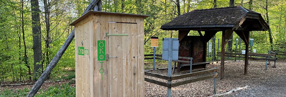 Nordholzwald im Hintergrund mit dem Ökotoi-WC im Vordergrund