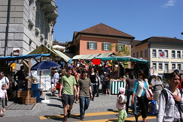 Menschen schlendern durch Marktstände