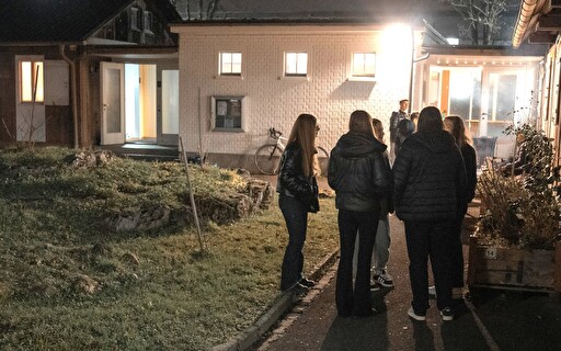 Jugendliche vor einem Gebäude.