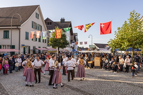 Männer und Frauen tanzen in Trachten