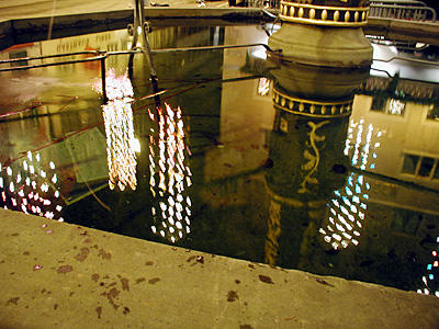 Im Kolinbrunnen beim Stadthaus spiegeln sich die Lichter.