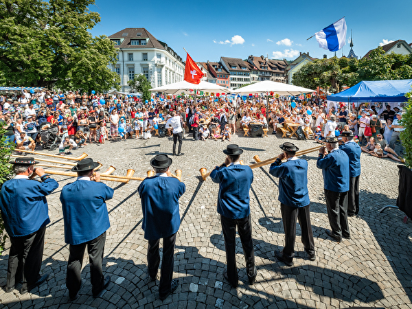 Zuger Alphornbläser in Grossformation mit Fahnenschwingern
