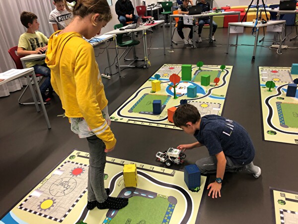 Schulkinder programmieren einen Roboter