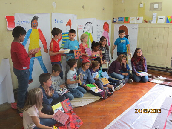 Kinder mit ihren gemalten Kunstwerken