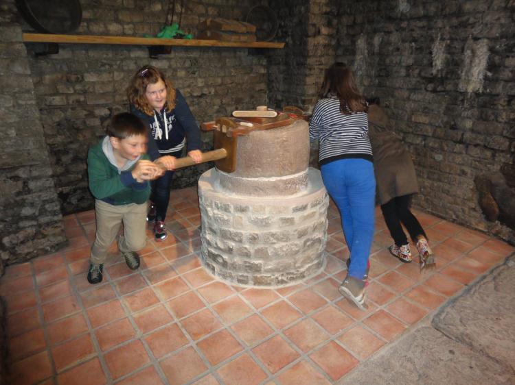 Der 200 kg schwere Mahlstein muss in Schwung gebracht werden. 