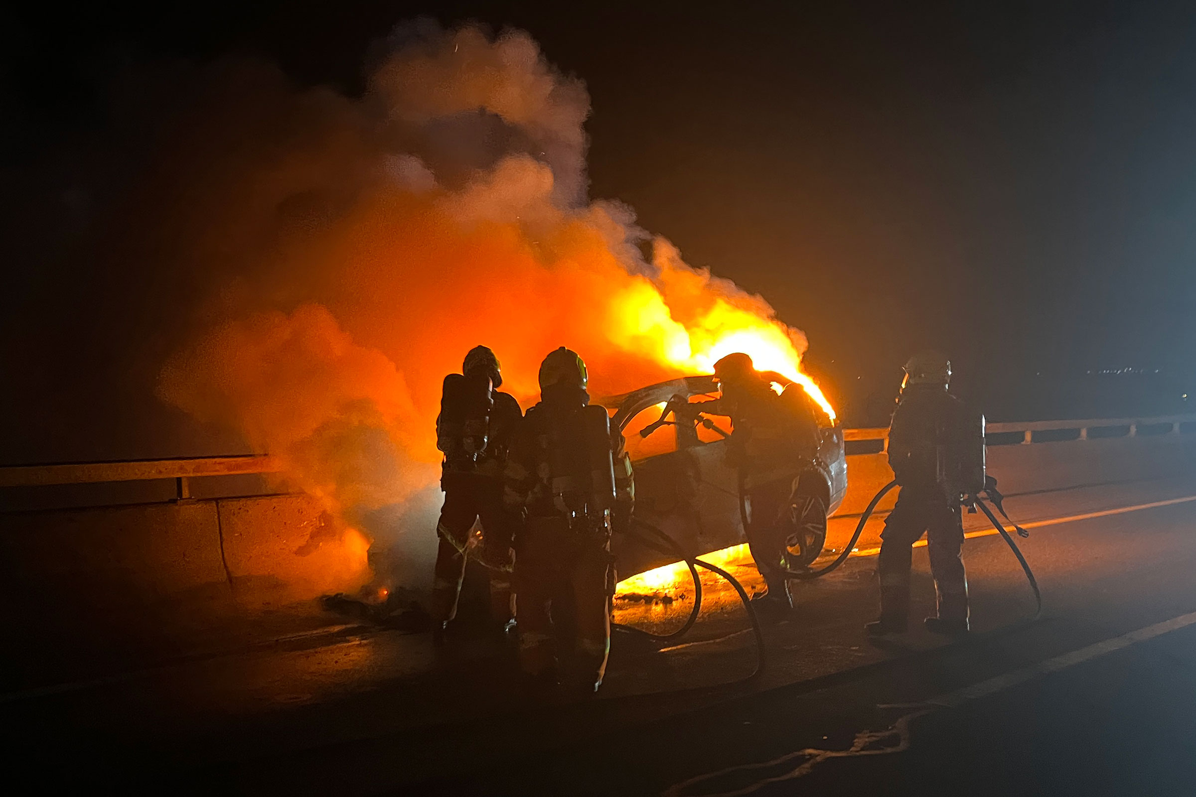 Auf dem Autobahnviadukt in Beckenried löscht das Ersteinsatzelement ein Auto.